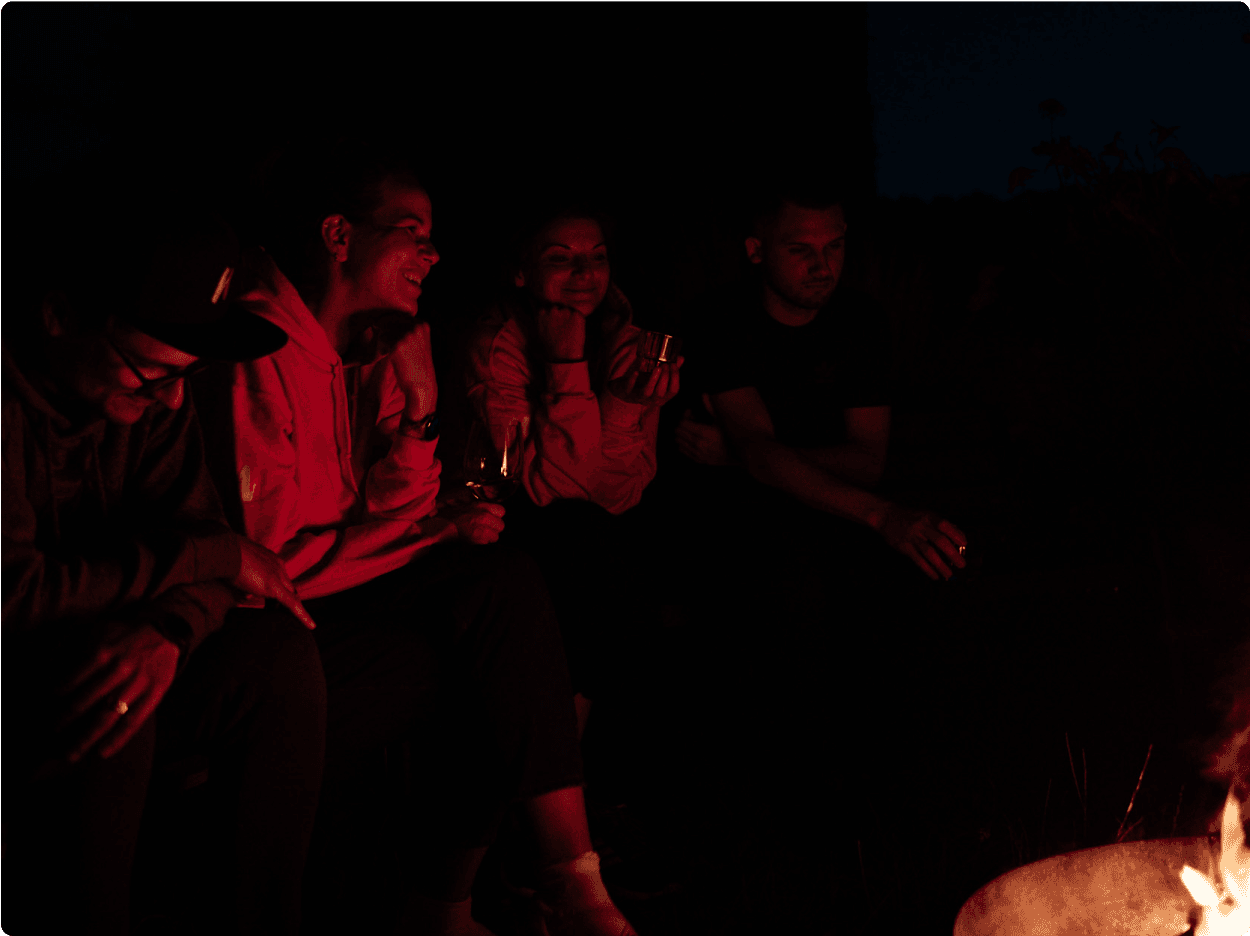 Naturaily employees chatting and smiling by the fire