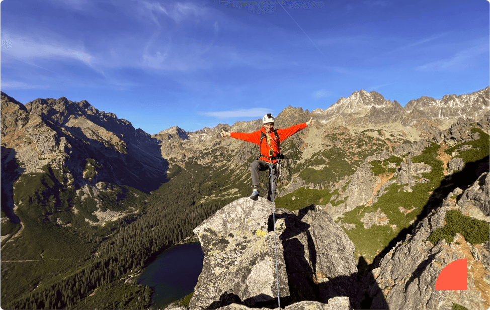 man standing on the top of a mountain