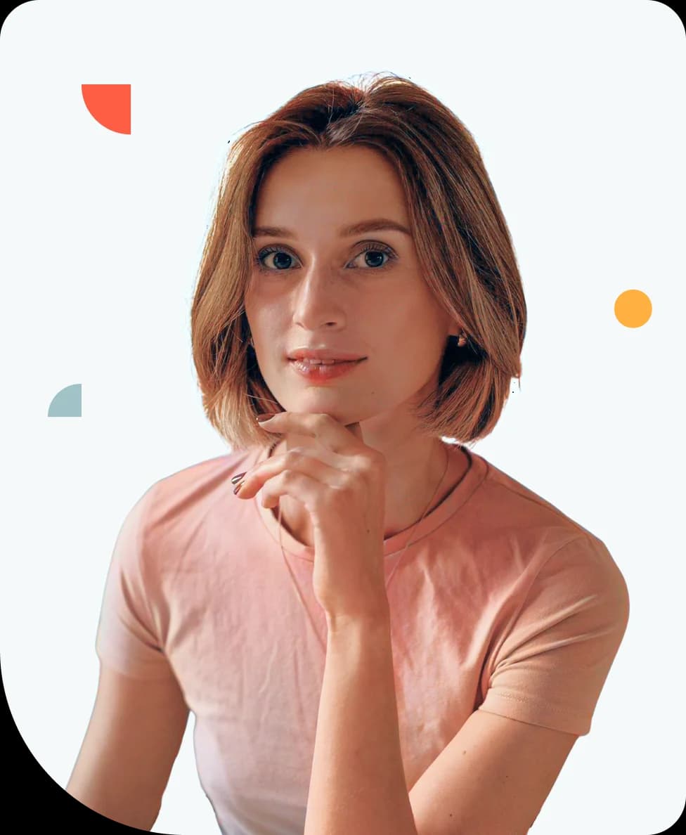 Polina Medvedieva, a person with short brown hair and a thoughtful expression, resting their chin on their hand, wearing a light pink shirt