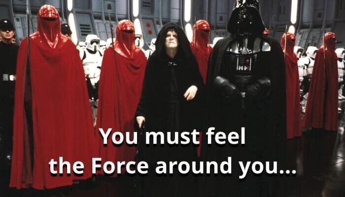 A group of characters in red and black robes stand in a futuristic setting. Text reads, "You must feel the Force around you..."