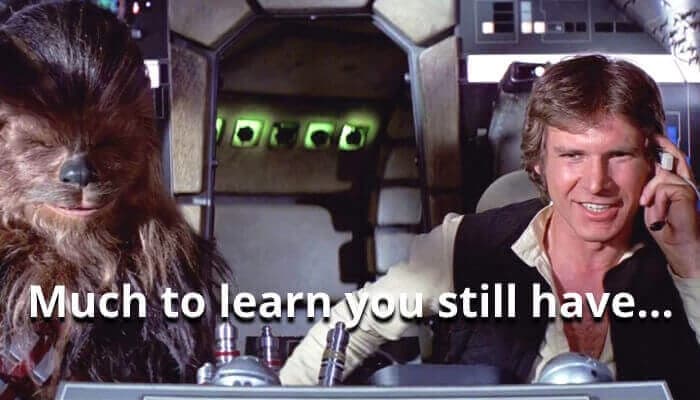 Chewbacca and a man sit in a spaceship cockpit. Text overlay reads, "Much to learn you still have..."