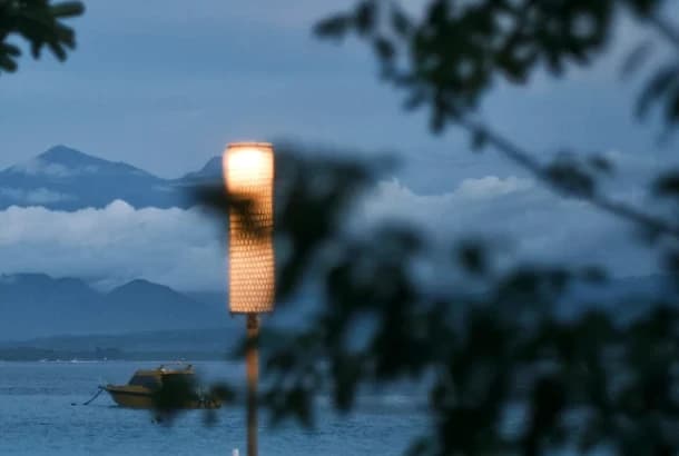 flexible hours benefit illustration - a boat on the sea with mountains in the background